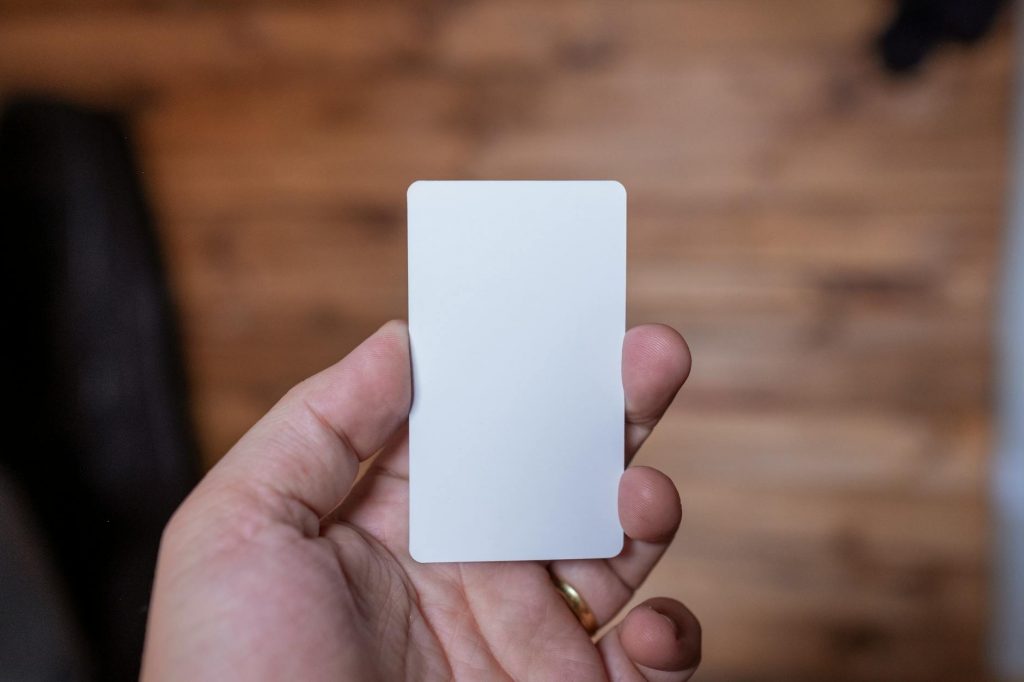 white card on persons hand